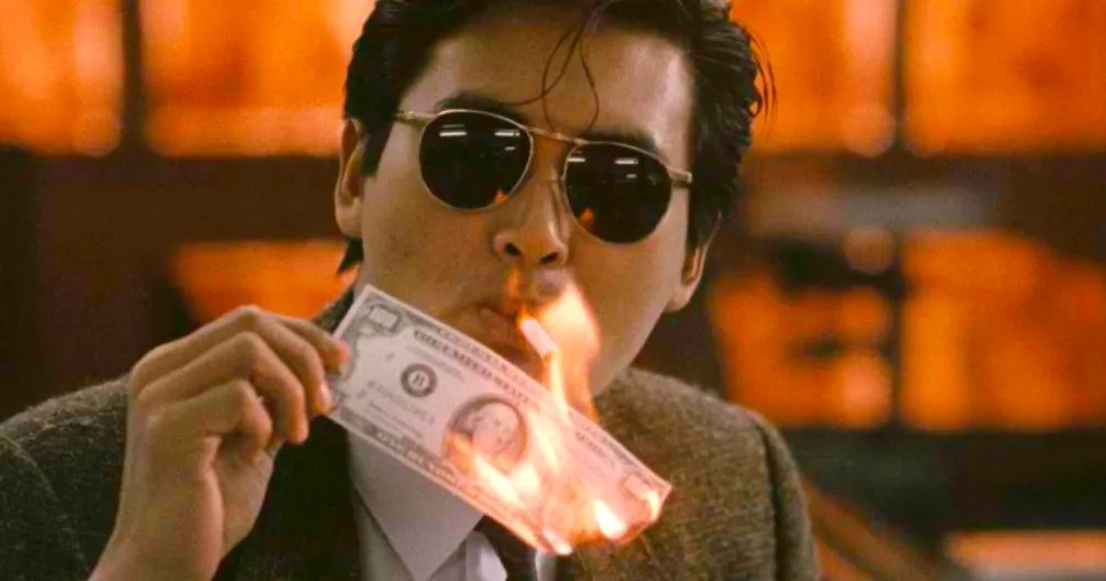 Man holding a bill on fire